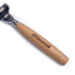 A close-up of the Akamai Basics SHAVE KIT razor featuring a wooden handle and stainless steel blade for eco-conscious personal care.